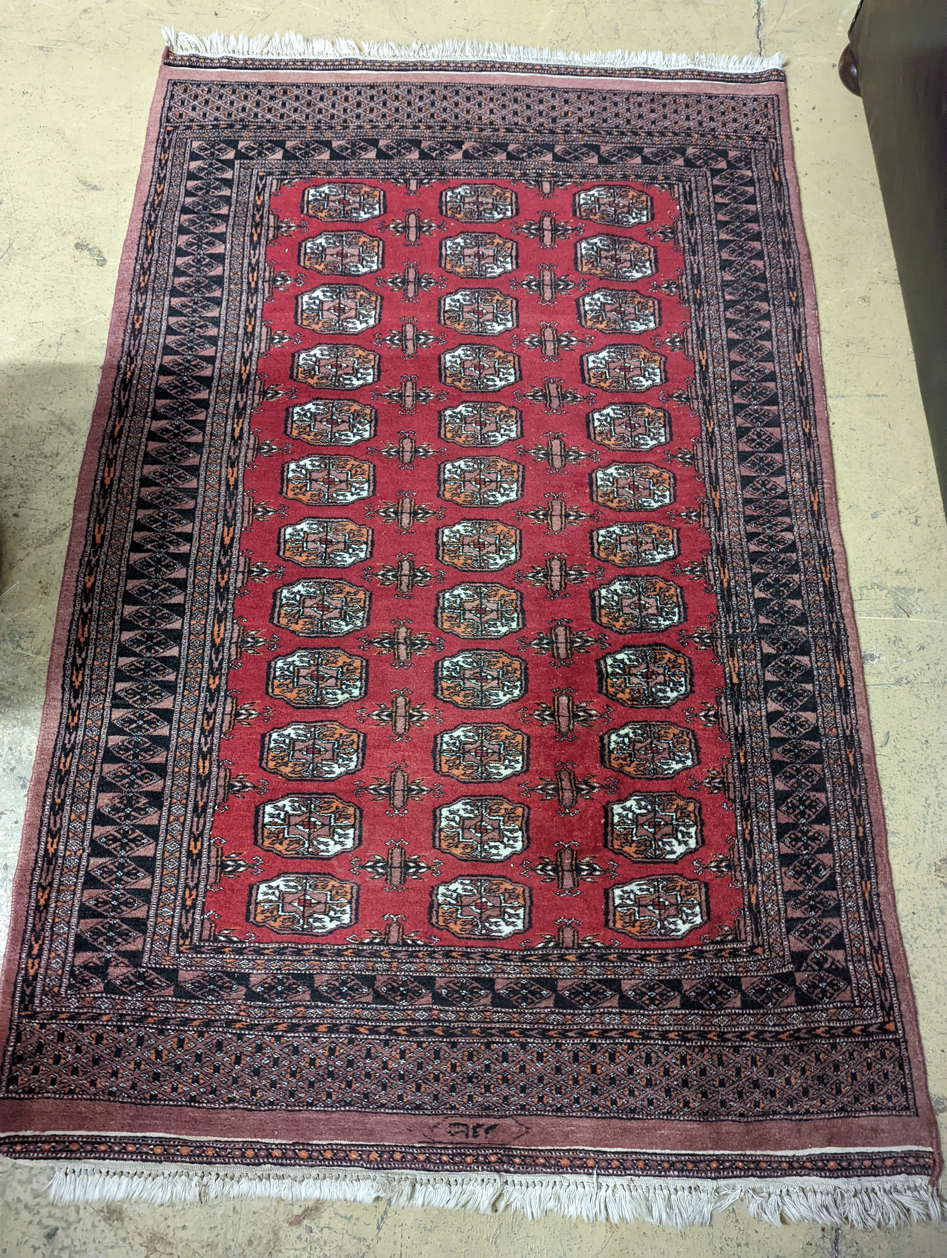 A Bokhara red ground rug, 196 x 126cm